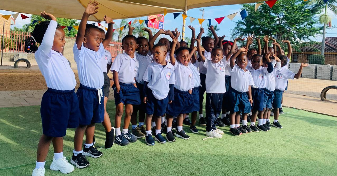 Primary school children in white uniforms attending class in Limpopo, South Africa